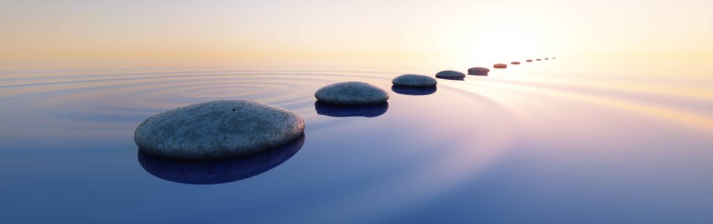 a row of rocks in water zen wellness feeling